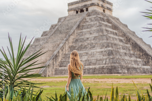 Obraz na płótnie Beautiful tourist woman observing the old pyramid and temple of the castle of the Mayan architecture known as Chichen Itza these are the ruins of this ancient pre-columbian civilization and part of w salonie