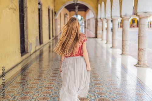 Woman tourist explores the vibrant streets of Valladolid, Mexico, immersing herself in the rich culture and colorful architecture of this charming colonial town photo