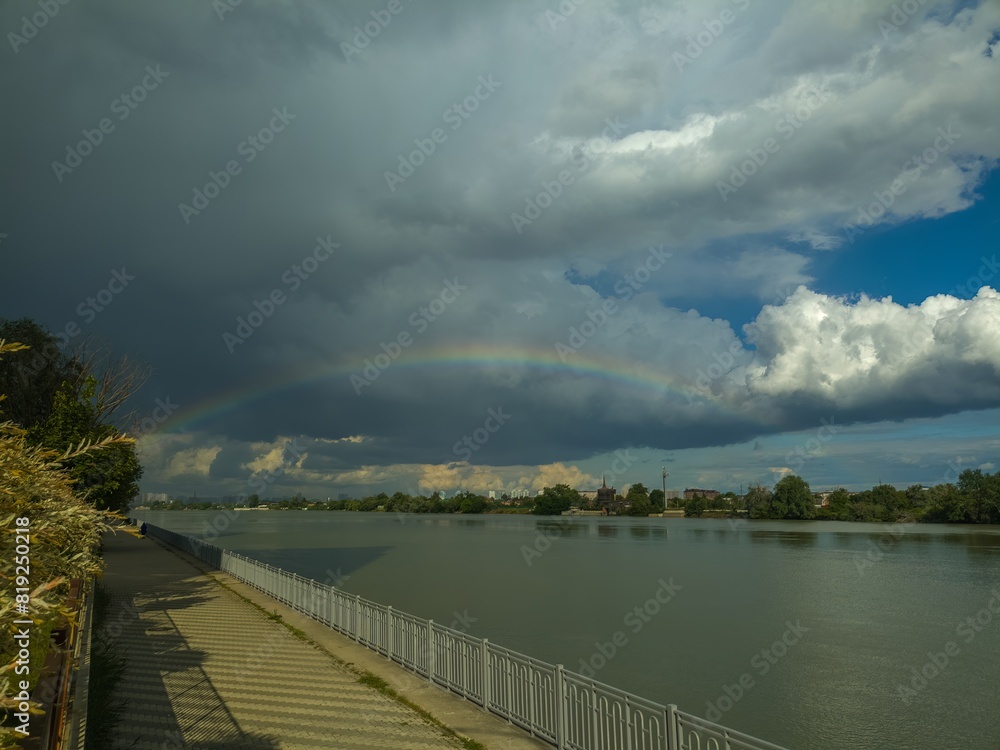 rainbow against the background of dark clouds over the Kuban River near the city of Krasnodar on a May day