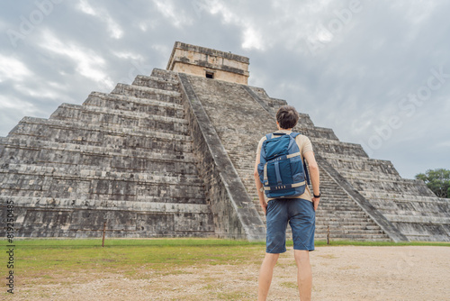 tourist man observing the old pyramid and temple of the castle of the Mayan architecture known as Chichen Itza these are the ruins of this ancient pre-columbian civilization and part of humanity photo