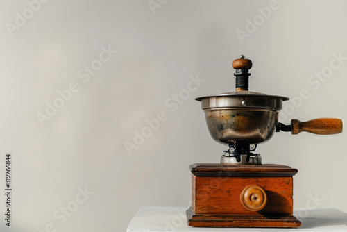 Retro manual coffee grinder on minimalist background