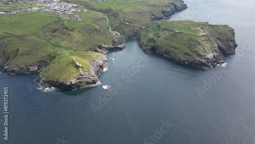 Tintagel Castle is a medieval fortification located on the peninsula of Tintagel Island adjacent to the village of Tintagel, North Cornwall in the United Kingdom. photo