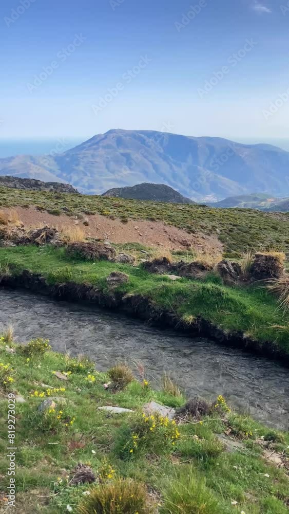Water stream flowing from melting snow in the spring, Sierra Nevada range, Andalusia, Spain Water stream flowing from melting snow in the spring, Sierra Nevada range, Andalusia, Spain