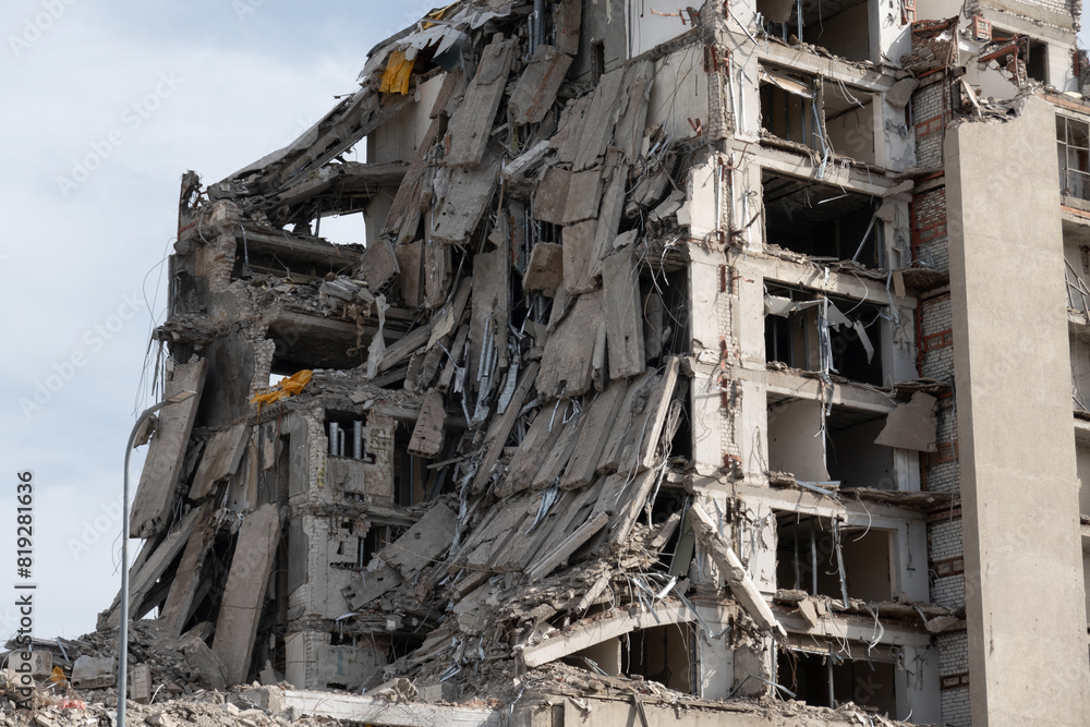 Image of a heavily damaged building with collapsed walls and debris, illustrating destruction and aftermath of a disaster. Image of a heavily damaged building with collapsed walls and debris, illustrating destruction and aftermath of a disaster.