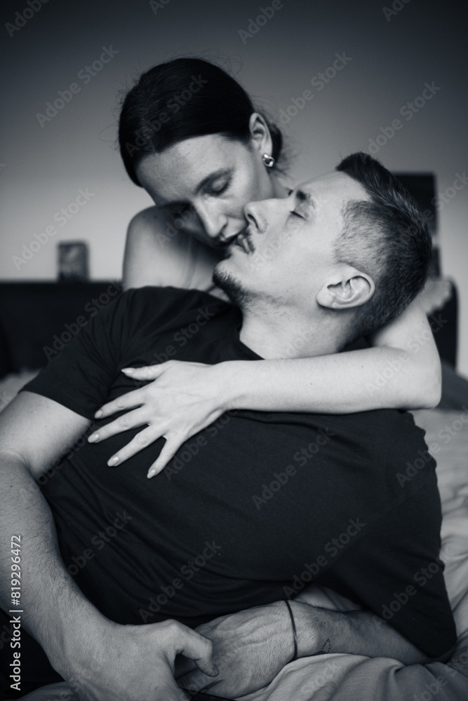 Sensual couple on the bed. A young and attractive man and woman kiss and hug, loving each other. Beautiful heterosexual couple of lovers Sensual couple on the bed. A young and attractive man and woman kiss and hug, loving each other. Beautiful heterosexual couple of lovers