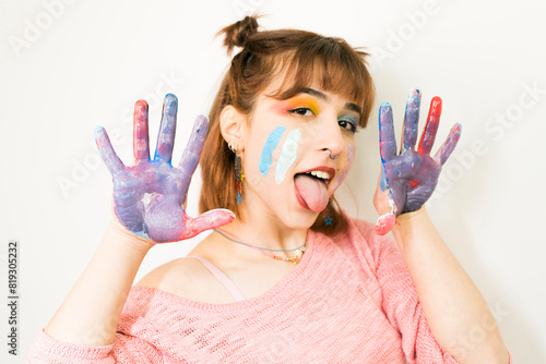 Happy woman hiding the face with her painted hands. Creative, art, childhood, drawing concept