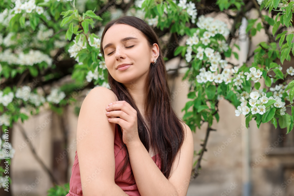 Beautiful woman near blossoming tree on spring day Beautiful woman near blossoming tree on spring day