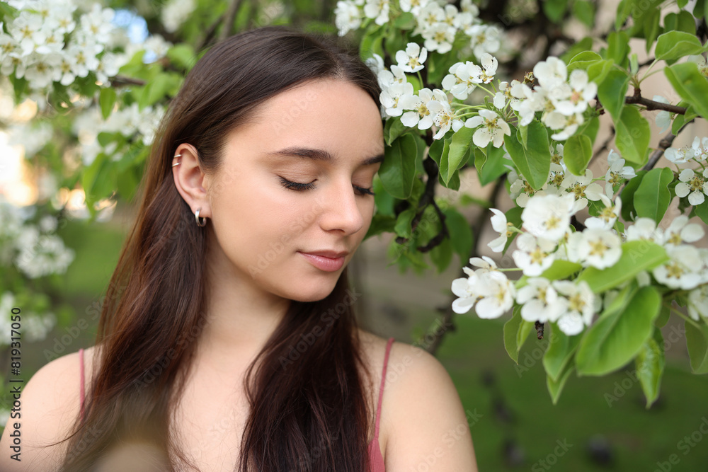 Beautiful woman near blossoming tree on spring day Beautiful woman near blossoming tree on spring day