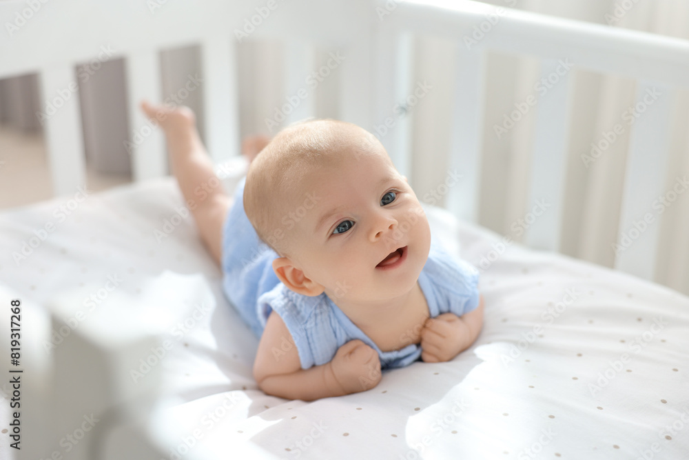 Cute little baby lying in crib at home Cute little baby lying in crib at home