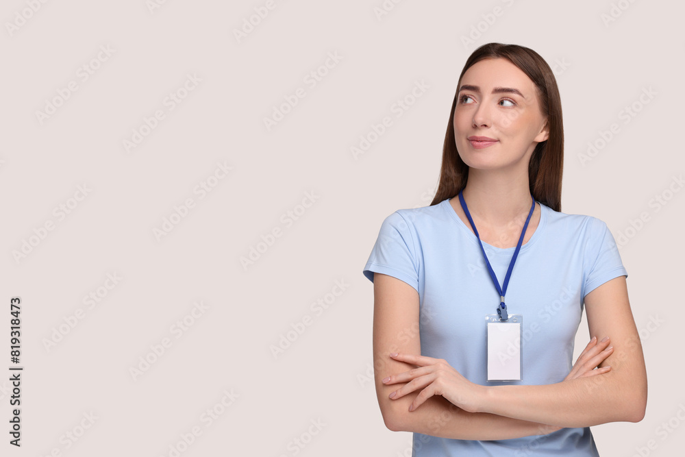 Woman with blank badge on grey background, space for text Woman with blank badge on grey background, space for text