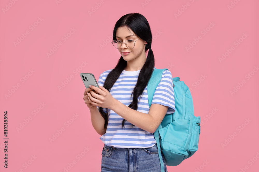 Student with smartphone and backpack on pink background Student with smartphone and backpack on pink background