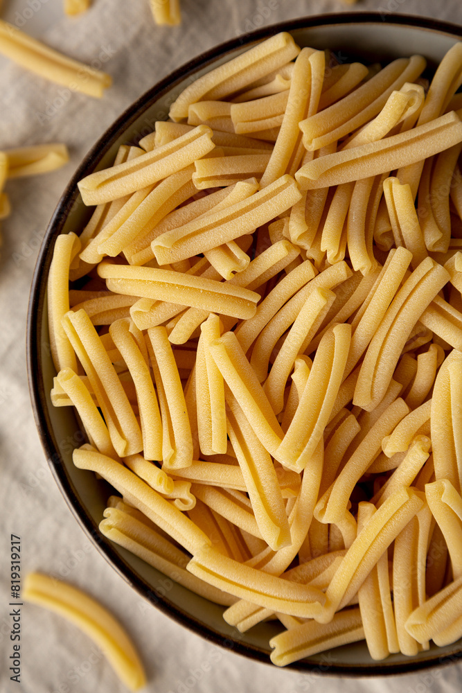 Dry Casarecce Pasta in a Bowl, top view. Close-up. Dry Casarecce Pasta in a Bowl, top view. Close-up.