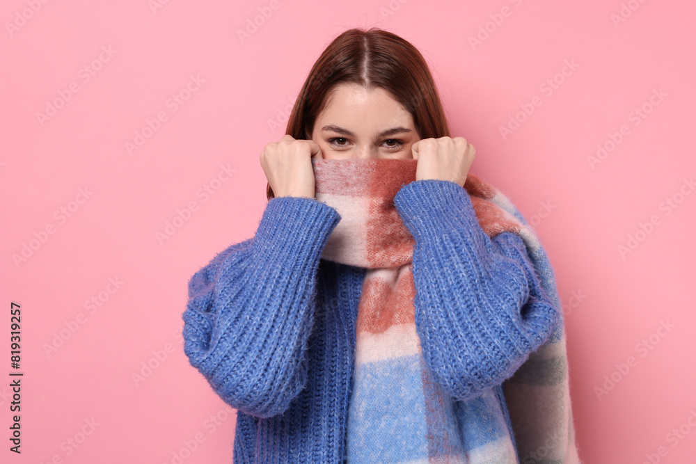 Beautiful woman in warm scarf on pink background Beautiful woman in warm scarf on pink background