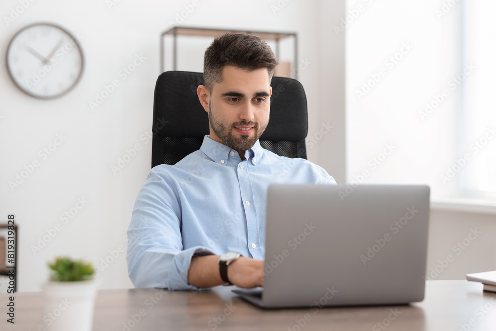 Happy young programmer working with laptop in office Happy young programmer working with laptop in office