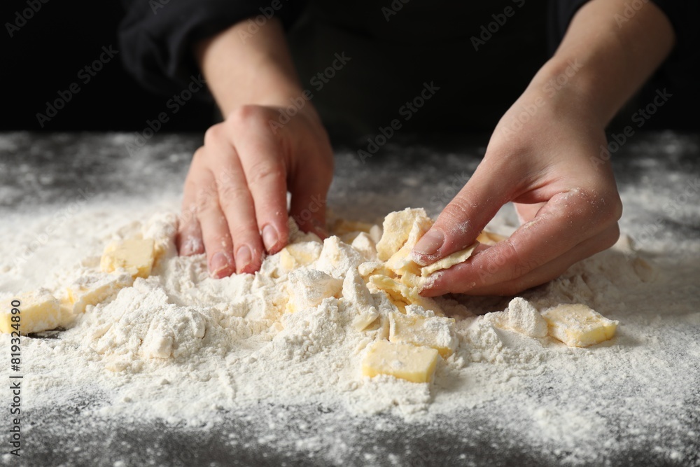 Woman making shortcrust pastry at table, closeup