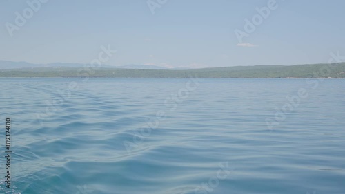 Aerial drone view of a blue sea water background and mountains