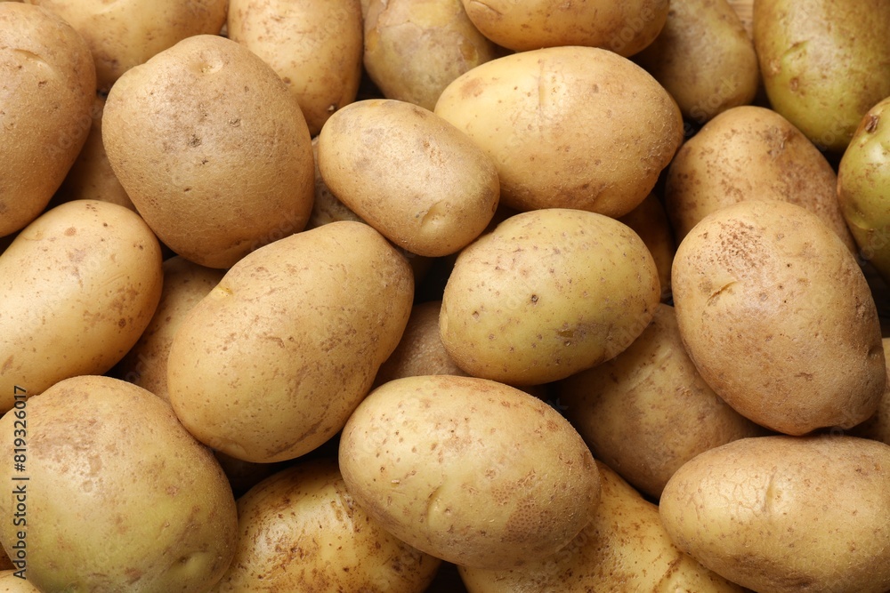 Fresh raw potatoes as background, top view Fresh raw potatoes as background, top view