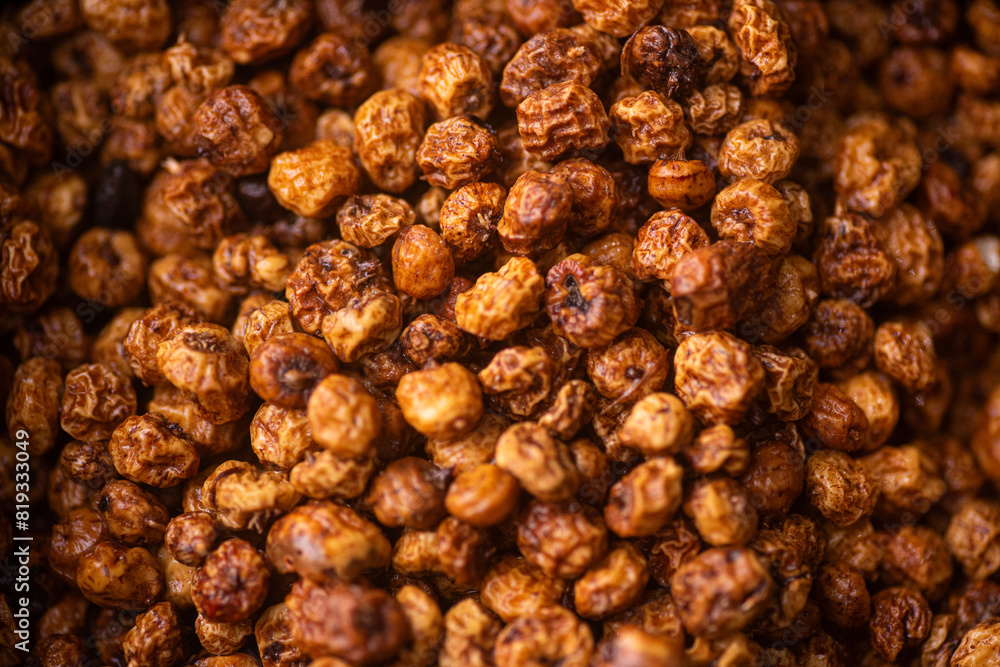 a pile of dry large orange tiger nuts wet with water and clean a pile of dry large orange tiger nuts wet with water and clean