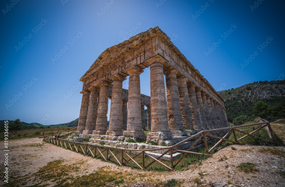 Naklejka premium Ruins of Greek temple in ancient city of Segesta, Sicily, Italy. June 2023