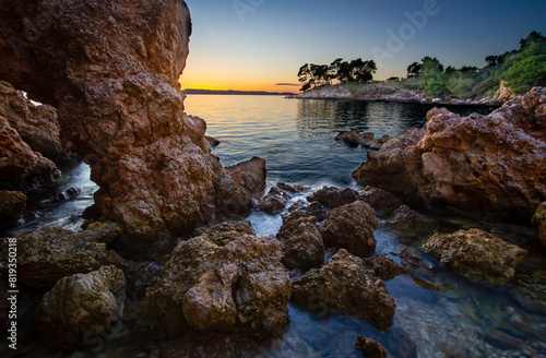 Rocky Shoreline at Sunset with Serene Ocean Views