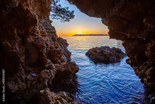 Sunset Through Coastal Cave Opening