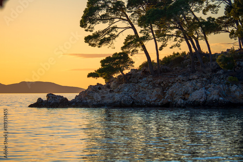 Sunset Over Rocky Island with Pine Trees