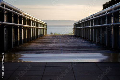 Scenic Boardwalk Leading to the Ocean at Sunrise