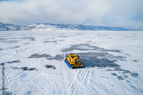Foto Aerial view on a hovercraft parked on the beautiful cracked ice of the lake Baikal