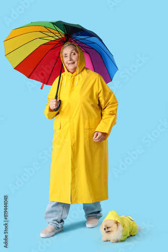 Senior woman in raincoat wi...