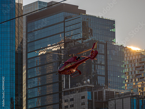 Aerospatiale Gazelle Lifting Off Past Cityscape photo