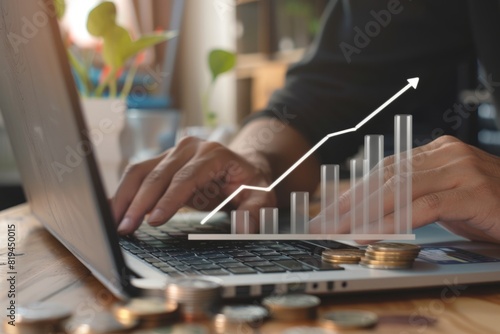 The concept of business growth with coins and graphs, in a flat lay composition on a wooden table, with a businessman using a laptop in the background,