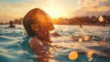 Woman swimming in sunset-lit water, wearing sunglasses, enjoying summer