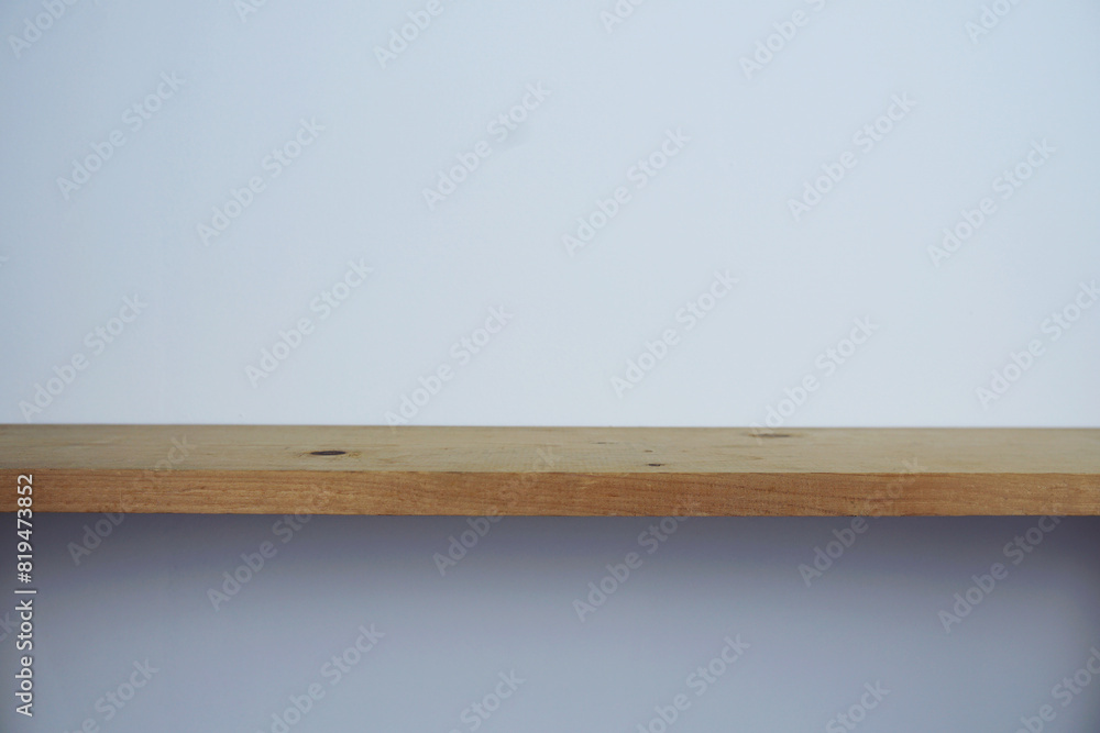 Wooden shelves on white concrete wall background For display Wooden shelves on white concrete wall background For display