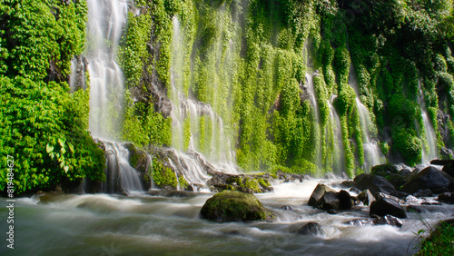 A waterfall with green moss growing on the rocks