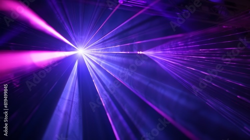 Blue and violet beams of laser light shine brilliantly against a black background, creating a dynamic and captivating visual effect.