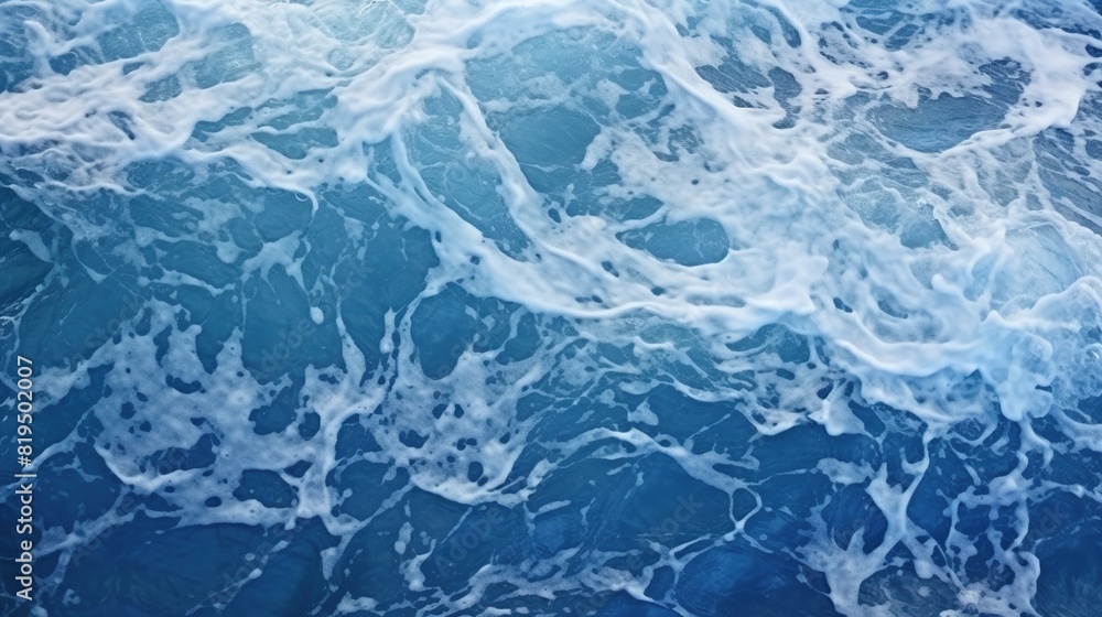 Blue ocean with white waves crashing on the shore. Image of a serene blue ocean with frothy white waves.