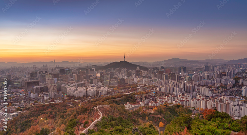 High angle view of Namsan Seoul Tower surrounded by cityscape of Seoul with sunlights in the morning, Seoul, South Korea