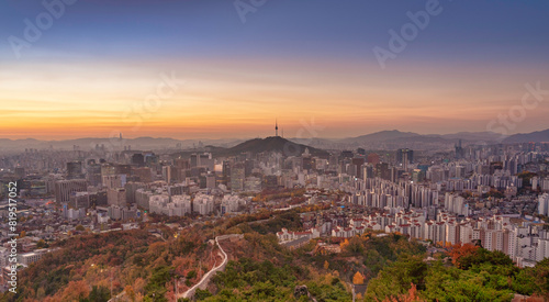 High angle view of Namsan Seoul Tower surrounded by cityscape of Seoul with sunlights in the morning, Seoul, South Korea