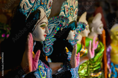 unfinished idols of goddess saraswati kept in a row for saraswati puja. partly decorated for the hindu religious occassion. photo