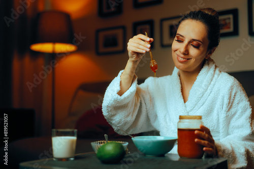 Woman Using Homemade Natural Honey Facial Treatments. Lady making her own face mask at hone with organic ingredients 
 photo