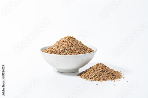 Dried herb in a white bowl on white background