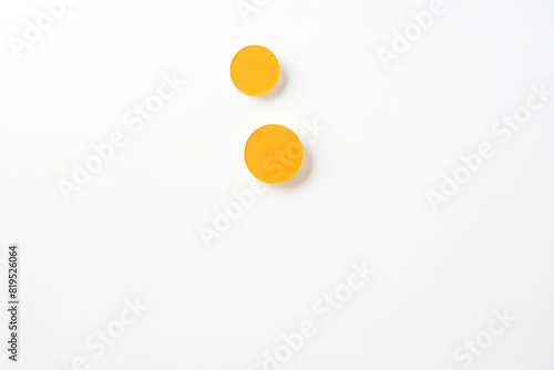 Two Yellow Round Objects on White Background © Rysak