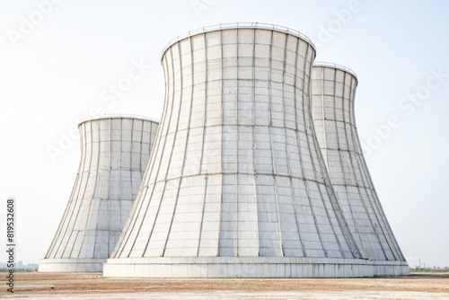 Three Large Cooling Towers in a Desert Landscape