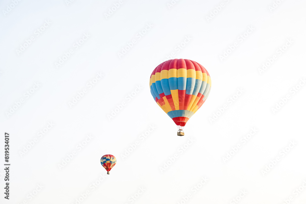 Fototapeta premium Hot Air Balloon Soaring in Blue Sky