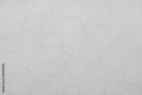 Cracks on the white plaster wall. Abstract design background.