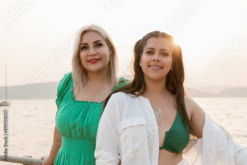 Two Women Smiling by the Lake at summer Sunset