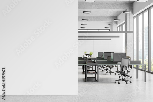 Modern office interior with pc monitors on tables, drawer and window. Mockup wall photo