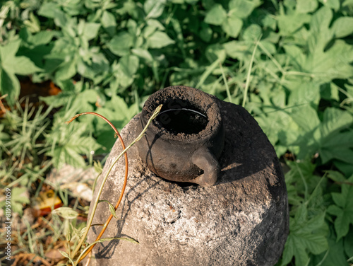 Pottery in the form of a small cup that was blackened from firing was on top of the stove photo