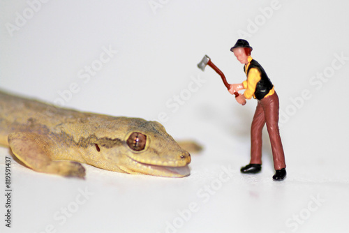 concept miniature figure, a man againt  lizard