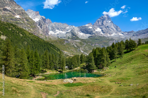 Small alpine lake and mountains with Matterhorn on background in Italy.